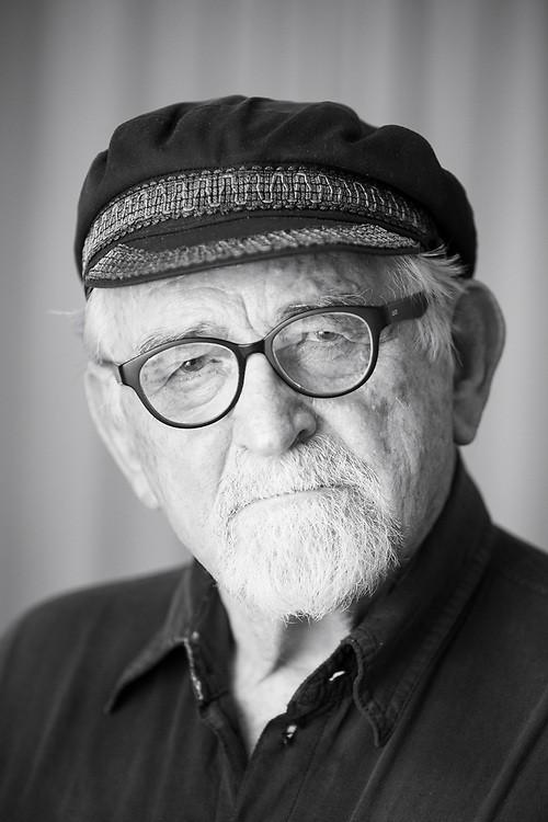 Terry Bell — a close-up portrait in his later years, cap and glasses